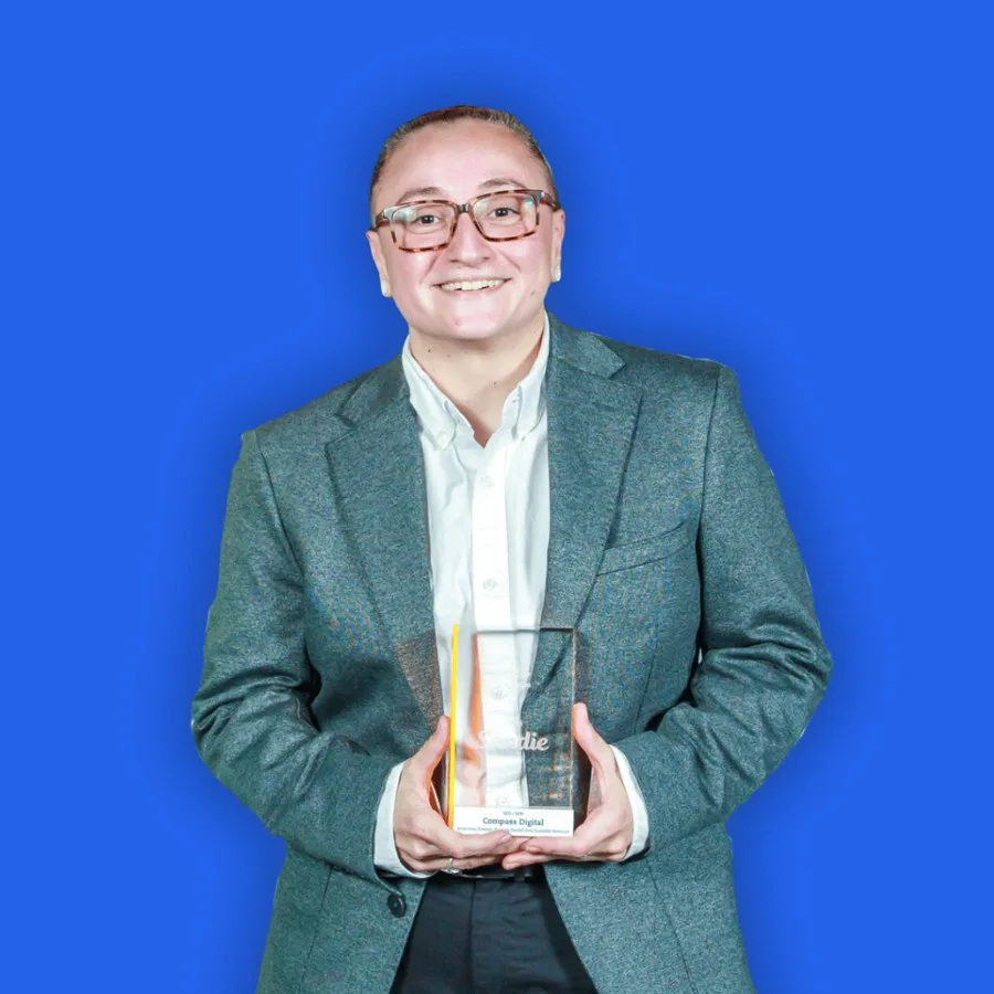 Radostina Stoycheva smiling and holding a Compass Digital marketing award